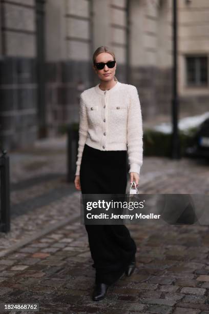 Marlies Pia Pfeifhofer seen wearing Ray-Ban Wayfarer black sunglasses, Vintage Dior gold statement earrings, H&M cream white boucle cardigan jacket,...