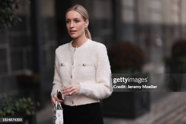 Marlies Pia Pfeifhofer seen wearing Ray-Ban Wayfarer black sunglasses, Vintage Dior gold statement earrings, H&M cream white boucle cardigan jacket,...