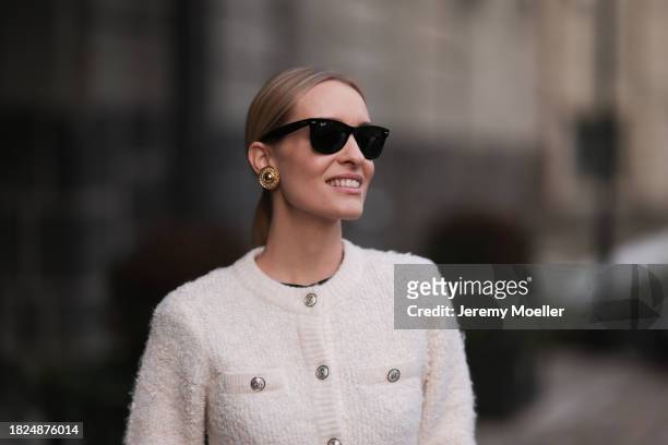 Marlies Pia Pfeifhofer seen wearing Ray-Ban Wayfarer black sunglasses, Vintage Dior gold statement earrings, H&M cream white boucle cardigan jacket,...