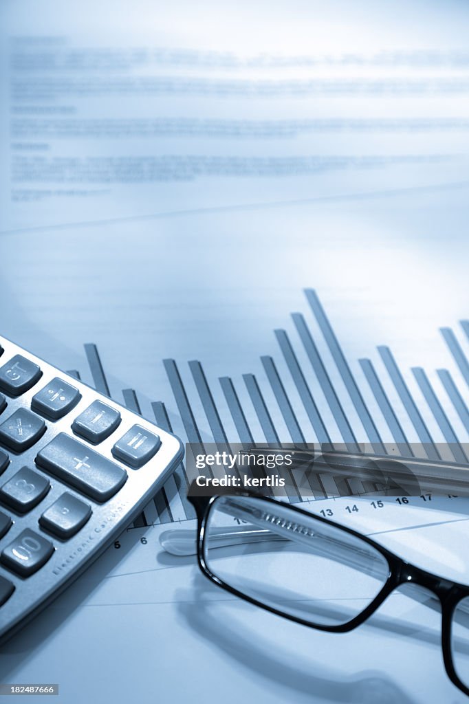An analytical graph chart and a pair of spectacles