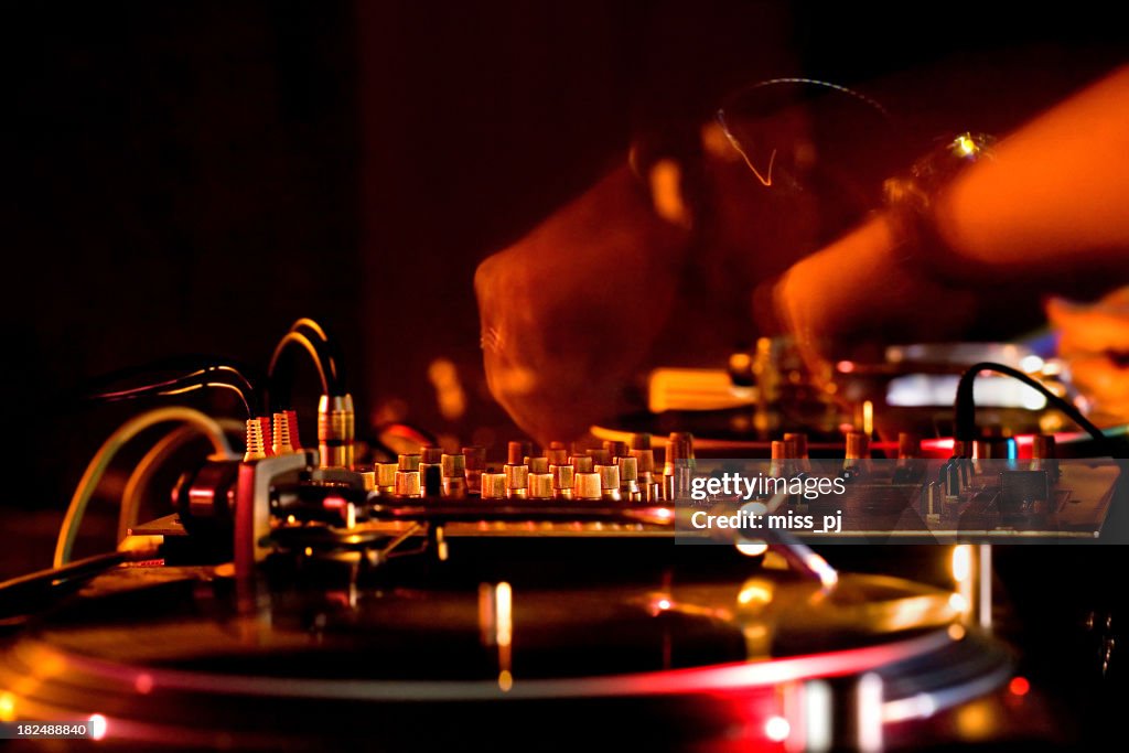 Close-up of DJ hands and sound equipment