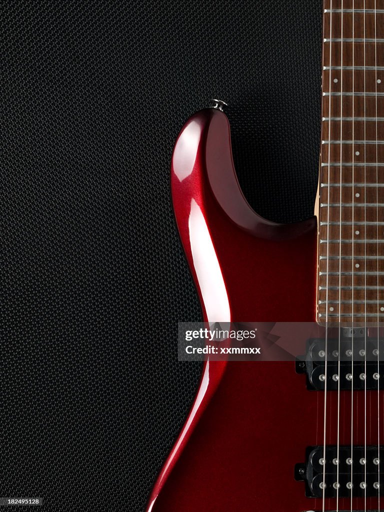 Guitar and black amplifier in the background