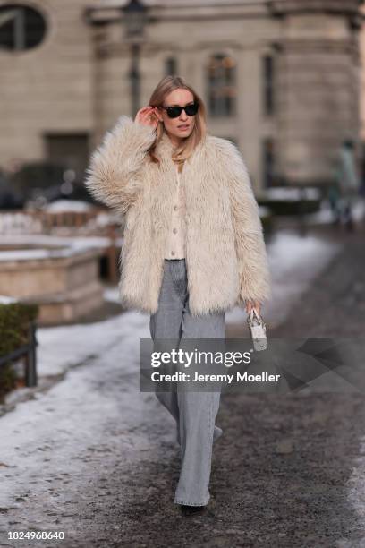 Marlies Pia Pfeifhofer seen wearing Ray-Ban Wayfarer black sunglasses, silver earrings, Dondup cream white fluffy fake fur jacket, Massimo Dutti...