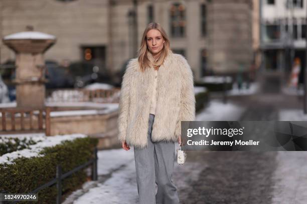 Marlies Pia Pfeifhofer seen wearing silver earrings, Dondup cream white fluffy fake fur jacket, Massimo Dutti light frey flared jeans / pants, Dior...