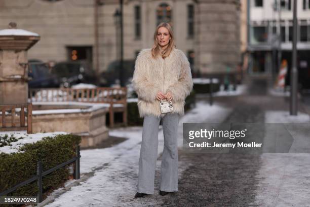 Marlies Pia Pfeifhofer seen wearing silver earrings, Dondup cream white fluffy fake fur jacket, Massimo Dutti light frey flared jeans / pants, Dior...