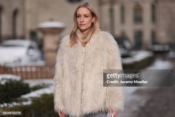 Marlies Pia Pfeifhofer seen wearing silver earrings, Dondup cream white fluffy fake fur jacket, Massimo Dutti light frey flared jeans / pants, on...