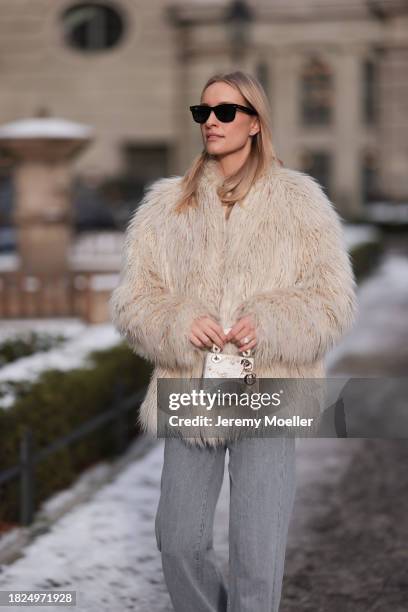 Marlies Pia Pfeifhofer seen wearing Ray-Ban Wayfarer black sunglasses, silver earrings, Dondup cream white fluffy fake fur jacket, Massimo Dutti...