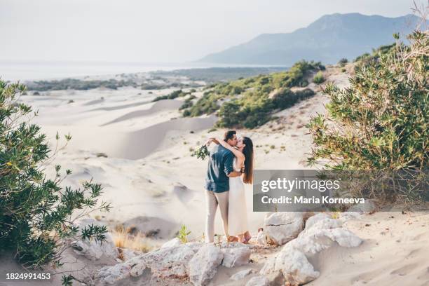 bride and groom walking holding hands in desert. - beach wedding stock pictures, royalty-free photos & images