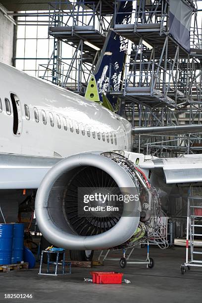 passenger jet during maintenance check in hangar - aircraft assembly plant stock pictures, royalty-free photos & images