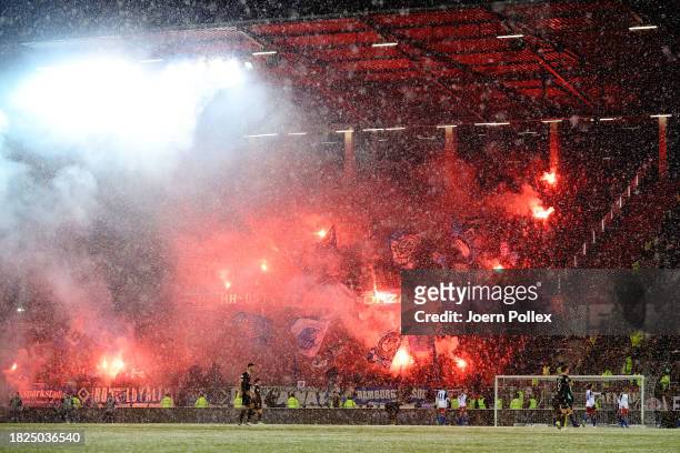 Fans of Hamburger SV wave flags and use pyrotechnics during the Second Bundesliga match between FC St. Pauli and Hamburger SV at Millerntor Stadium...