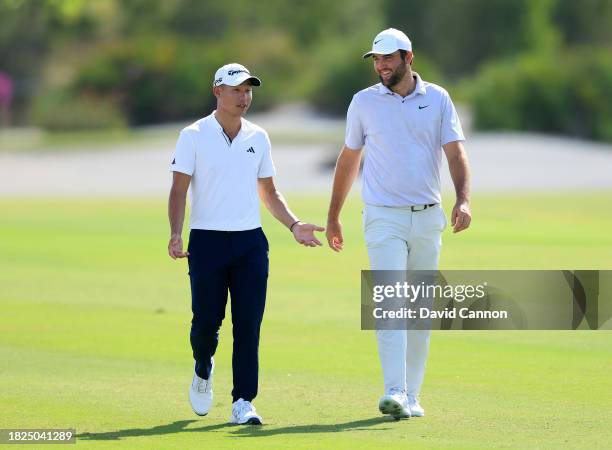 Collin Morikawa of The United States and Scottie Scheffler of The United States walk to their second shots on the third hole during the second round...