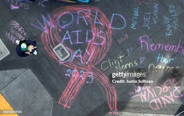In an aerial view, names of the victims of AIDS are seen written in chalk on Castro Street on December 01, 2023 in San Francisco, California. World...