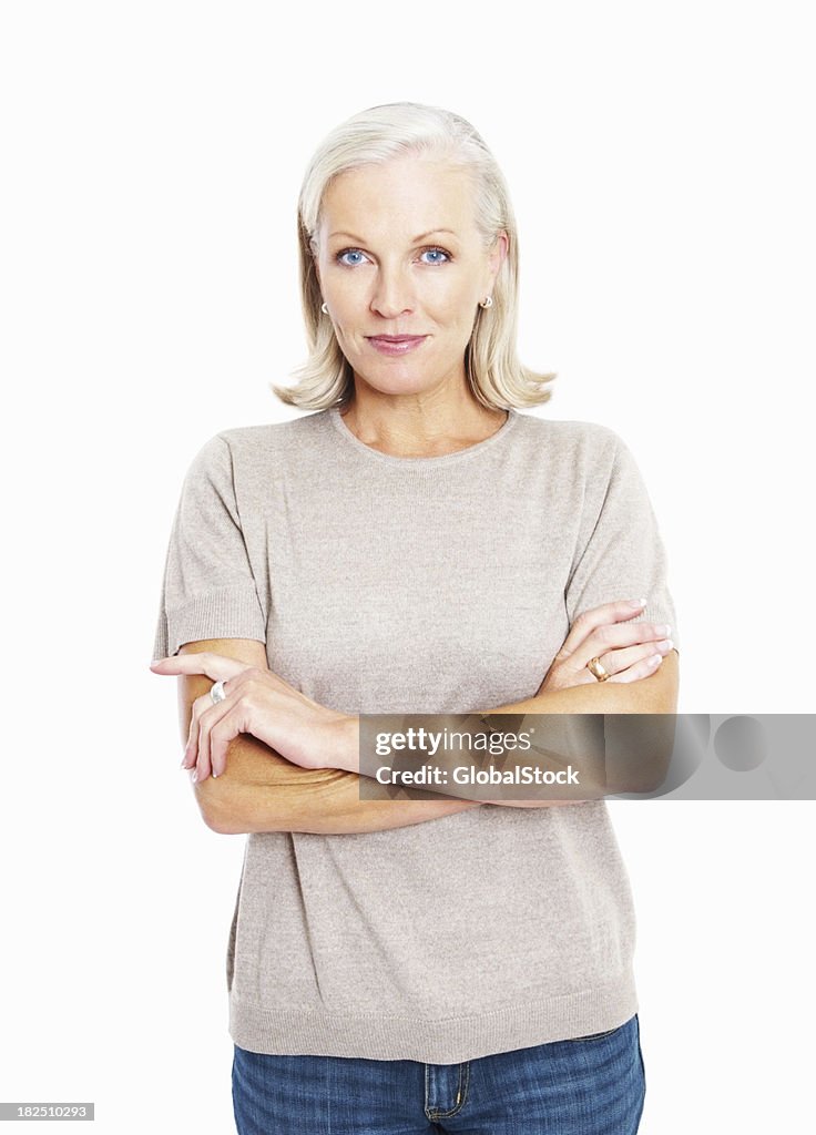 Smiling confident mature woman standing arms crossed against white