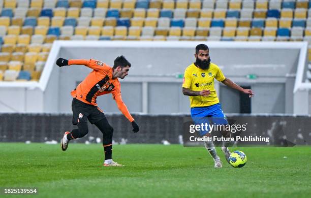 Defender Irakli Azarov of FC Shakhtar Donetsk is seen in action with midfielder Ari Moura of FC Metalist 1925 Kharkiv during the 2023/2024 Ukrainian...