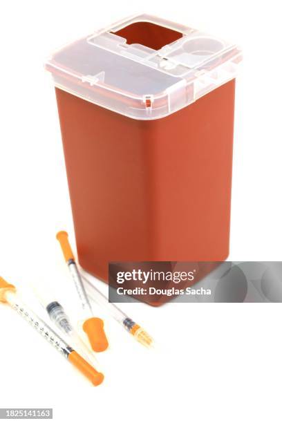 sharps container for biohazard hypodermic needle waste - vintage syringe stock pictures, royalty-free photos & images