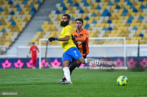 Defender Irakli Azarov of FC Shakhtar Donetsk is seen in action with midfielder Ari Moura of FC Metalist 1925 Kharkiv during the 2023/2024 Ukrainian...