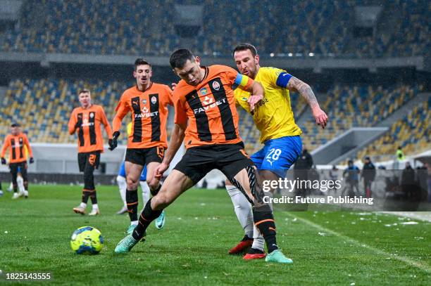 Midfielder Taras Stepanenko of FC Shakhtar Donetsk and midfielder Artem Habelok of FC Metalist 1925 Kharkiv are seen in action during the 2023/2024...