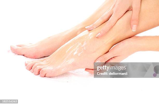 smearing footcare (crema - pie humano fotografías e imágenes de stock