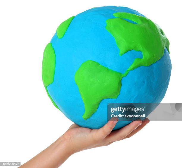 child holding a clay globe on white - child's play clay stock pictures, royalty-free photos & images