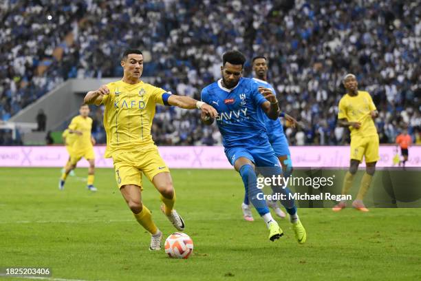 Al Hilal's Ali Al Bulayhi, right, fights for the ball with Urawa