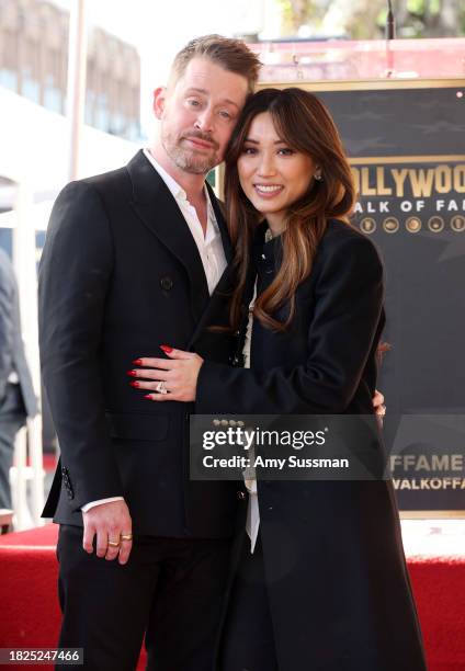 Macaulay Culkin and Brenda Song attend the ceremony honoring Macaulay Culkin with a Star on the Hollywood Walk of Fame on December 01, 2023 in...