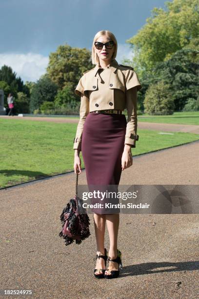 Model Elena Perminova wears Chanel sunglasses, Burberry jacket and bag, Aperlai shoes , skirt, top and belt from H and M on day 4 of London Fashion...