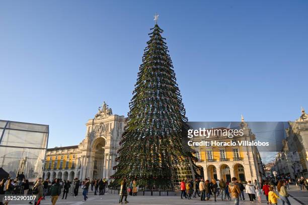 Crowd gathers to watch fireworks and laser show during the lighting of a large Christmas tree and buildings in Praça do Comercio on December 01, 2023...