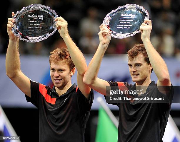 Jamie Murray of Britain and team mate John Peers of Australia pose with their Thailand Open trophies after defeating Tomasz Bednarek of Poland and...