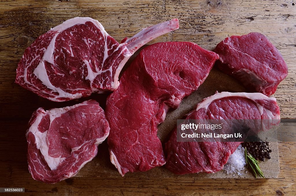 Beef steak cuts on stone platter
