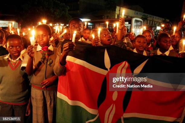 Pupils of Nyeri Good Shepherd School during prayers and tributes for the Westgate Terror attack victims on September 27, 2013 outside Raybells...