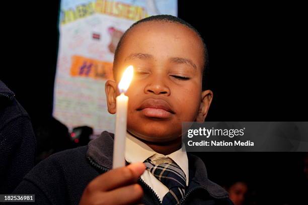 Mt Kenya Academy's Brian Wamahiu during prayers and tributes for the Westgate Terror attack victims on September 27, 2013 outside Raybells restaurant...