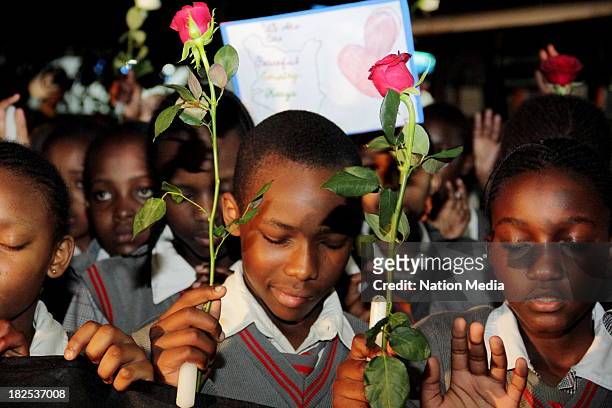 Pupils of Nyeri Good Shepherd during prayers and tributes for the Westgate Terror attack victims on September 27, 2013 outside Raybells restaurant in...
