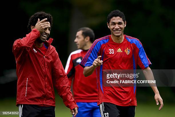Basel's Egyptian midfielder Mohamed Salah shares a light moment with compatriot midfielder Mohamed Elneny during a training session on September 30,...