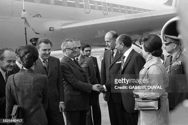 Egyptian president Anwar Sadat shakes hand to French Minister of Foreign Trade Norbert Segard while French President Valery Giscard d'Estaing arrives...