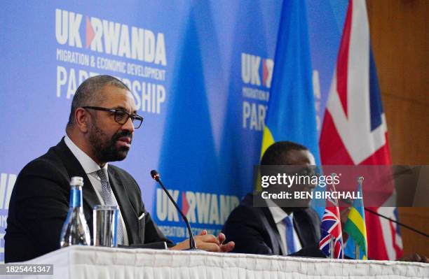 Britain's Home Secretary James Cleverly and Rwanda's Foreign Minister Vincent Biruta attend a joint press conference after signing a new treaty, in...