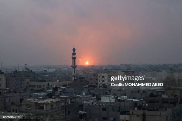 This picture taken from Rafah in the southern Gaza Strip on December 5, 2023 shows an explosion in Khan Yunis as battles between Israel and Hamas...