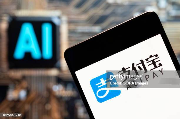 In this photo illustration, the Chinese online payment platform owned by Alibaba Group, Alipay logo seen displayed on a smartphone with an Artificial...