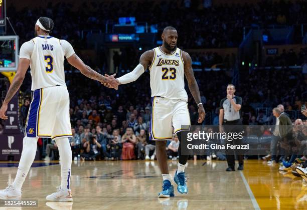 Los Angeles Lakers forward Anthony Davis hand slaps Los Angeles Lakers forward LeBron James after James scored against the Houston Rockets at...