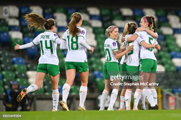 Belfast , United Kingdom - 5 December 2023; Republic of Ireland players celebrate after their first goal, scored by Lucy Quinn, hidden, during the...