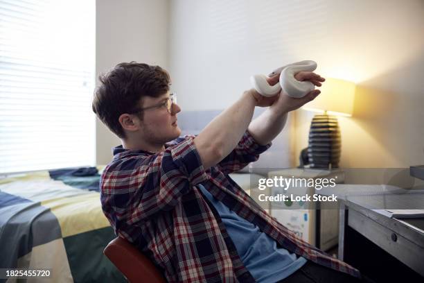 college student with ball python in dorm room - albino animals stock pictures, royalty-free photos & images