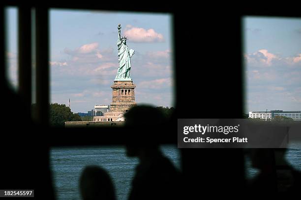 People view the Statue of Liberty, one of New York's premiere tourist attractions, from the Staten Island Ferry on September 30, 2013 in New York...