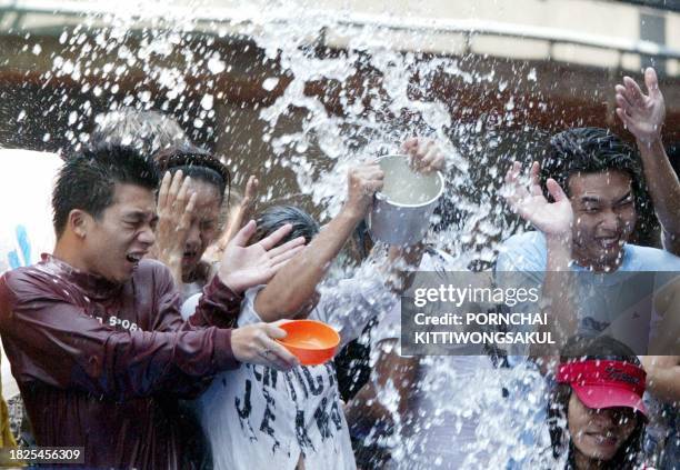 Thai teenagers enjoy a water fight during Songkran festival celebrations at Silom Road in Bangkok, 13 April 2003. Songkran is the celebration of...