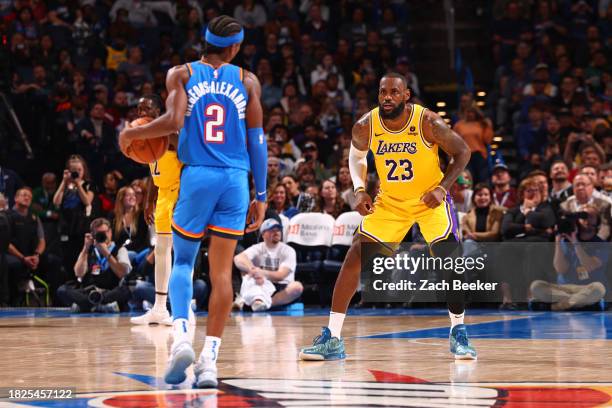 LeBron James of the Los Angeles Lakers defends Shai Gilgeous-Alexander of the Oklahoma City Thunder during the game on November 30, 2023 at Paycom...