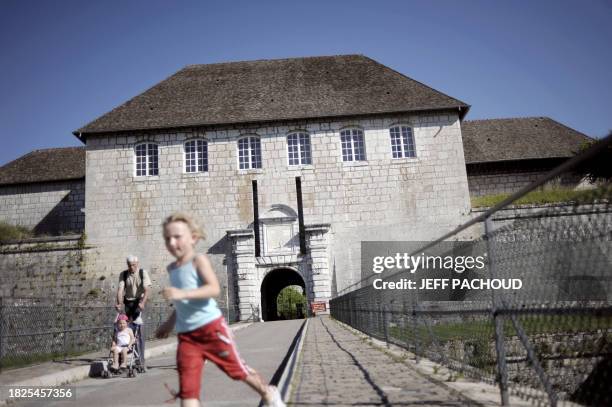 People walk on July 10 in Besancon, eastern France in front of the entrance of the town's citadel, which was added to the list of World Heritage...