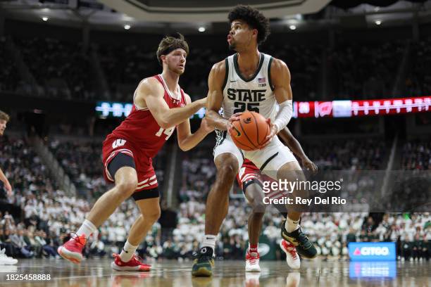 Malik Hall of the Michigan State Spartans drives to the basket against Carter Gilmore of the Wisconsin Badgers in the first half at Breslin Center on...