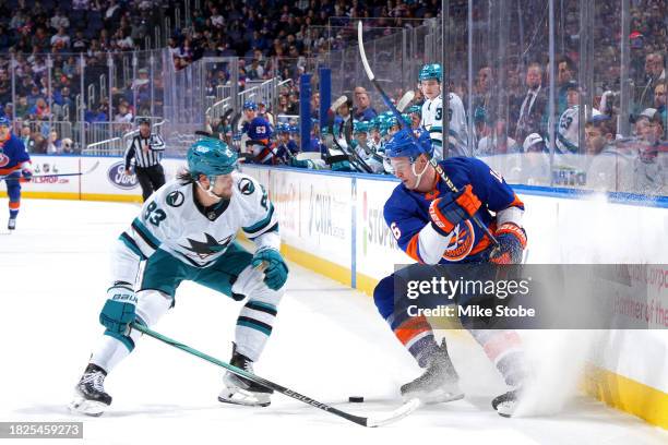 Julien Gauthier of the New York Islanders is defended by Nikita Okhotiuk of the San Jose Sharks during the first period at UBS Arena on December 05,...