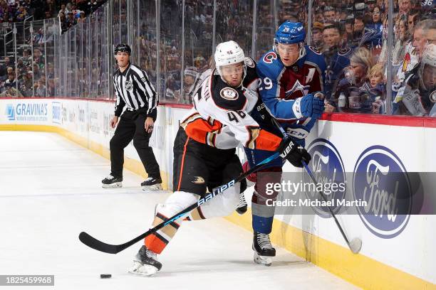 Ilya Lyubushkin of the Anaheim Ducks skates against Nathan MacKinnon of the Colorado Avalanche at Ball Arena on December 5, 2023 in Denver, Colorado.