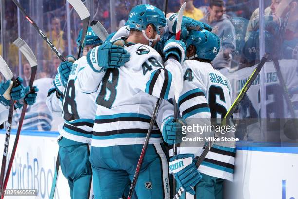 William Eklund of the San Jose Sharks is congratulated by his teammates after scoring a goal against the New York Islanders during ovetime at UBS...