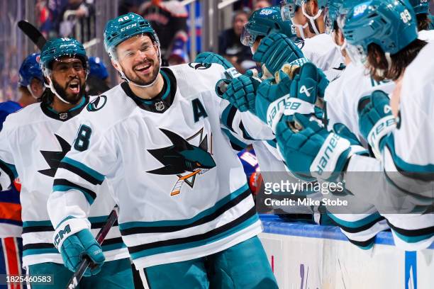 Tomas Hertl of the San Jose Sharks celebrates with teammates after scoring his third goal of the game against the New York Islanders during the third...