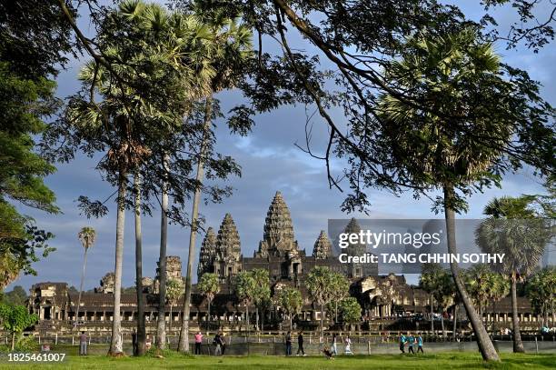 This photo taken on November 17, 2023 shows tourists visiting the Angkor Wat temple in Siem Reap province. Thailand, Cambodia and Vietnam are...